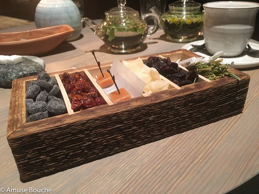 wooden box filled with smoked caramel, dried black currants at Faviken